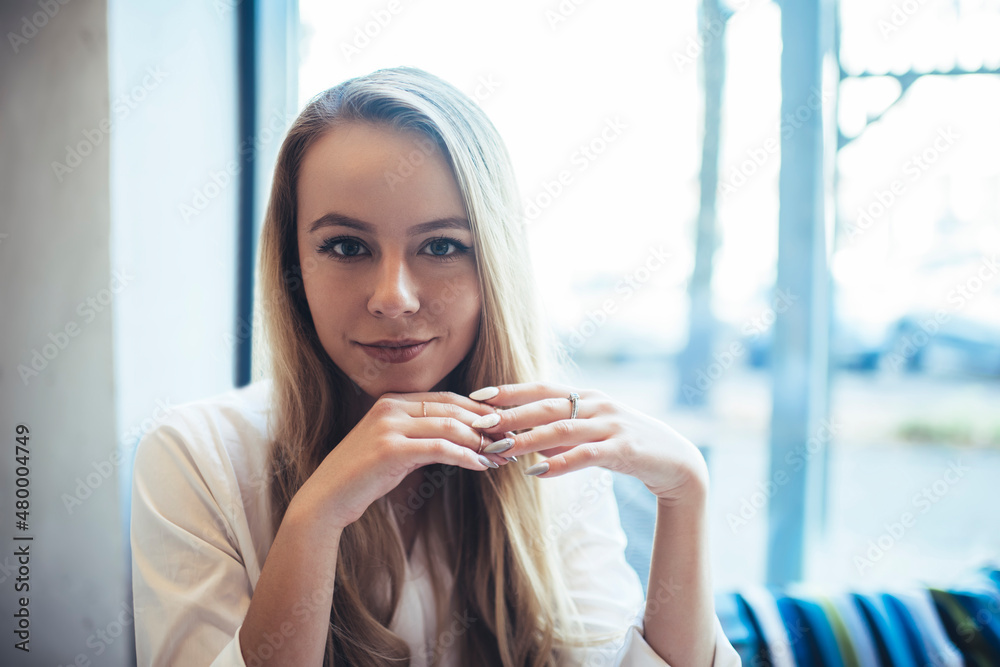 Positive woman in light cafeteria near window Positive woman in light cafeteria near window