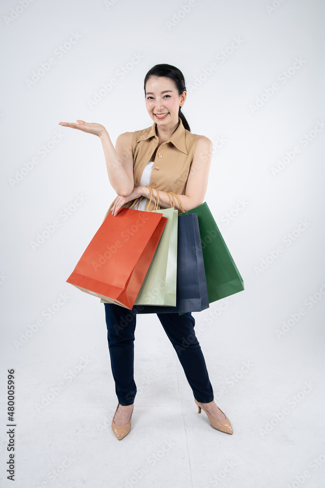 Woman holding paper bags on white background.