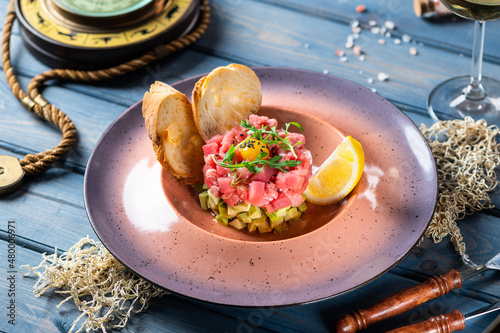 Tablou pe pânză Tuna tartare with avocado, quail egg and black sesame seeds-1