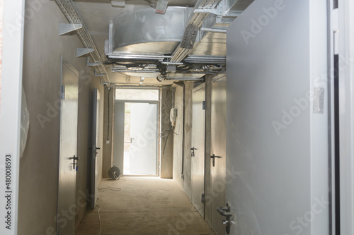 Corridor in an industrial building with fire doors and ventilation system. Selective focus photo