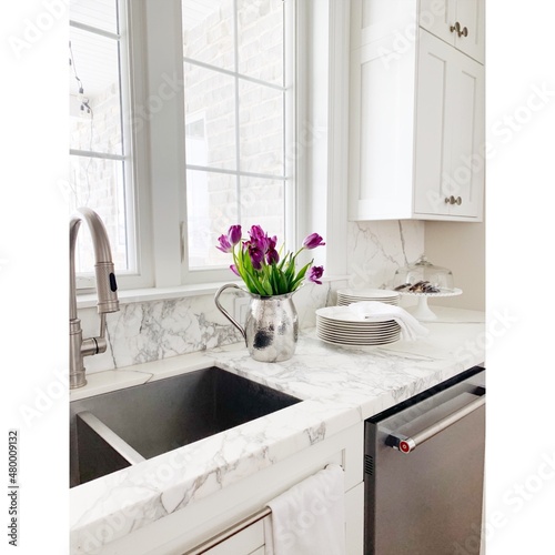 white marble kitchen sink with flowers