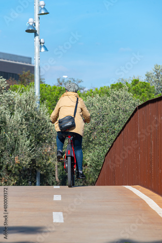 A girl circulating on the bike lane in the city of Barcelona