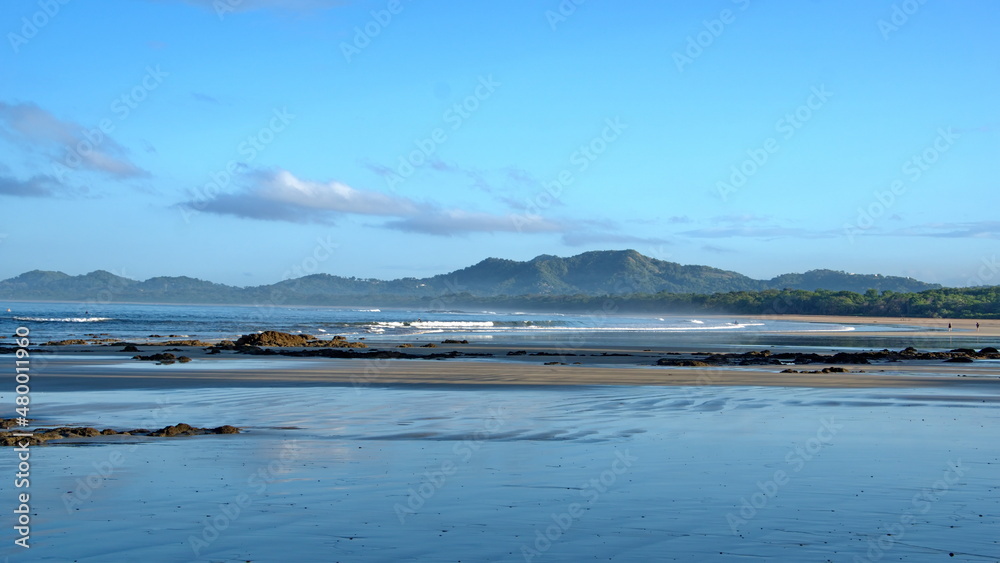 Landscape with a beach in front of the mountains in Tamarindo, Costa Rica