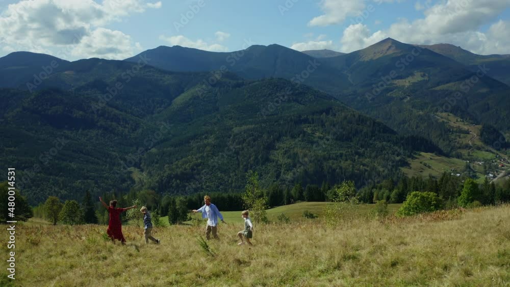 Family against mountains dancing enjoying time looking green woods pikes Family against mountains dancing enjoying time looking green woods pikes