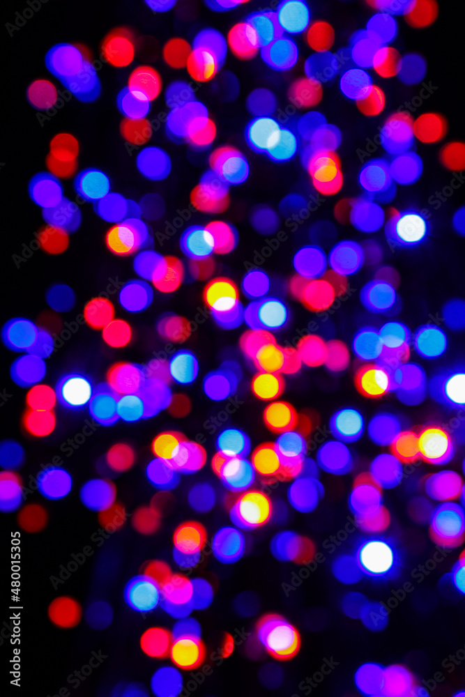Beautiful multicolored bokeh of holiday lights at night.