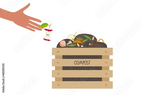 Human hand throws core apple in box with compost. Wooden Composting box with kitchen leftovers. Food waste. Environmentally responsible behavior. Garbage sorting. Recycling concept.