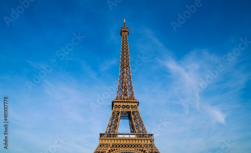 Paris Eiffel Tower and bright blue sky in Paris  France. Eiffel Tower is one of the most iconic landmarks of Paris. Copy space for your text.