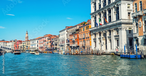 Colorful facades of old medieval houses in Venice  Italy. View on canal with boats and motorboats. Picturesque landscape. Retro vintage Instagram style filter effect.