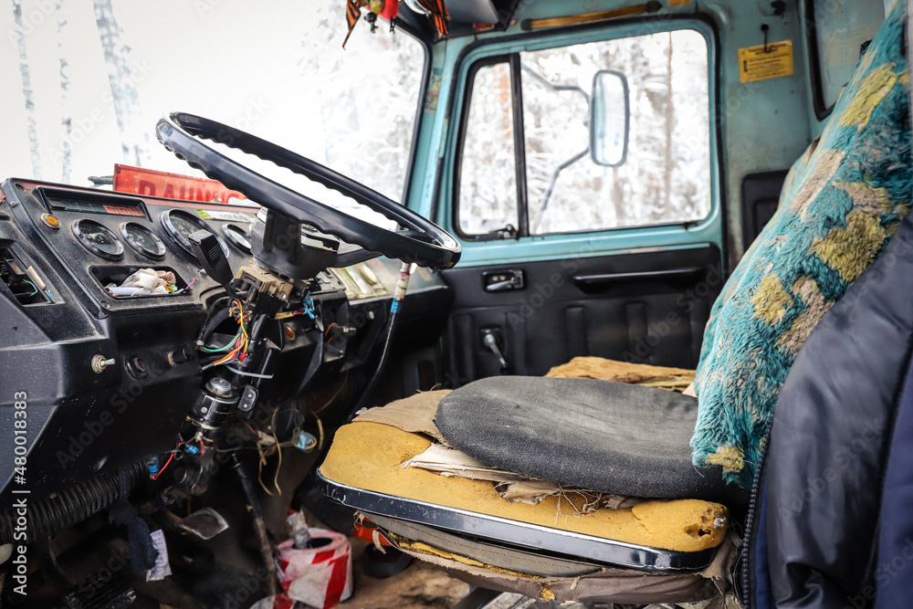 Interior of an old truck with a broken seat
