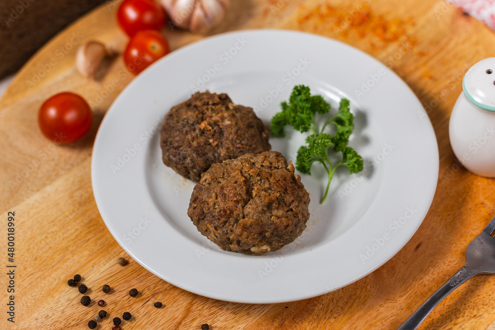 lamb and beef meat cutlets on a white plate in a cafe lamb and beef meat cutlets on a white plate in a cafe