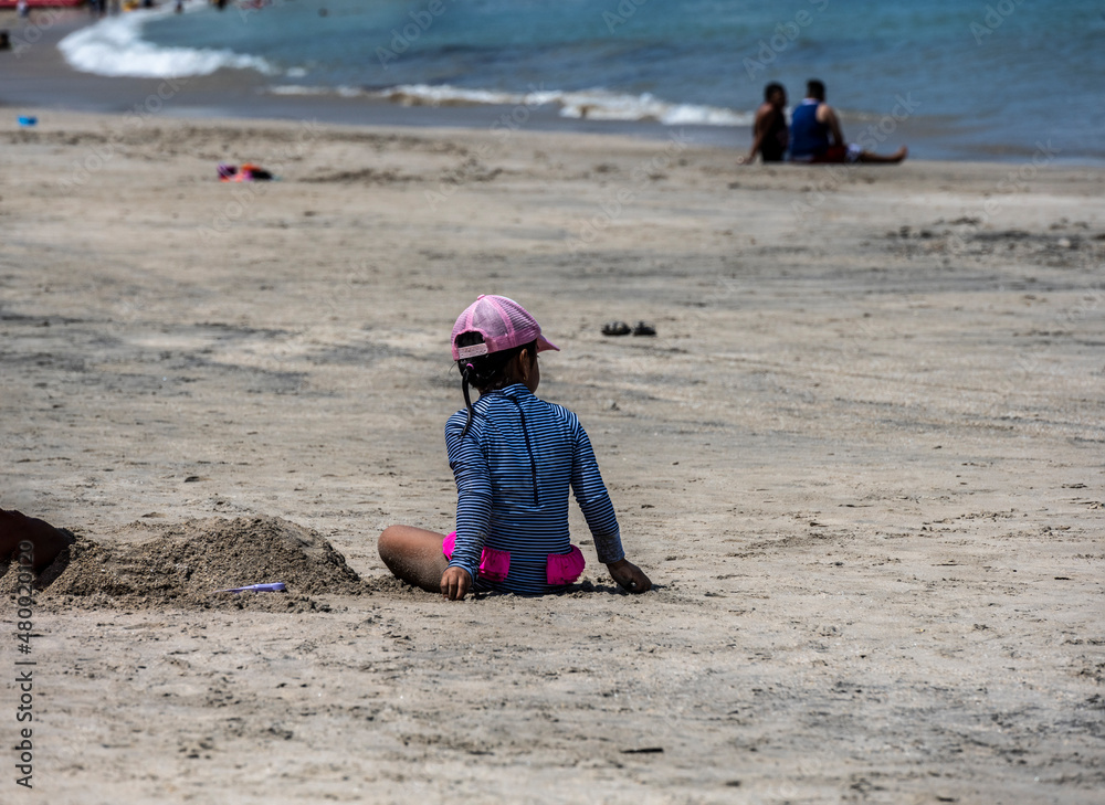 happy hispanic children play on the sandy shore near the sea happy hispanic children play on the sandy shore near the sea