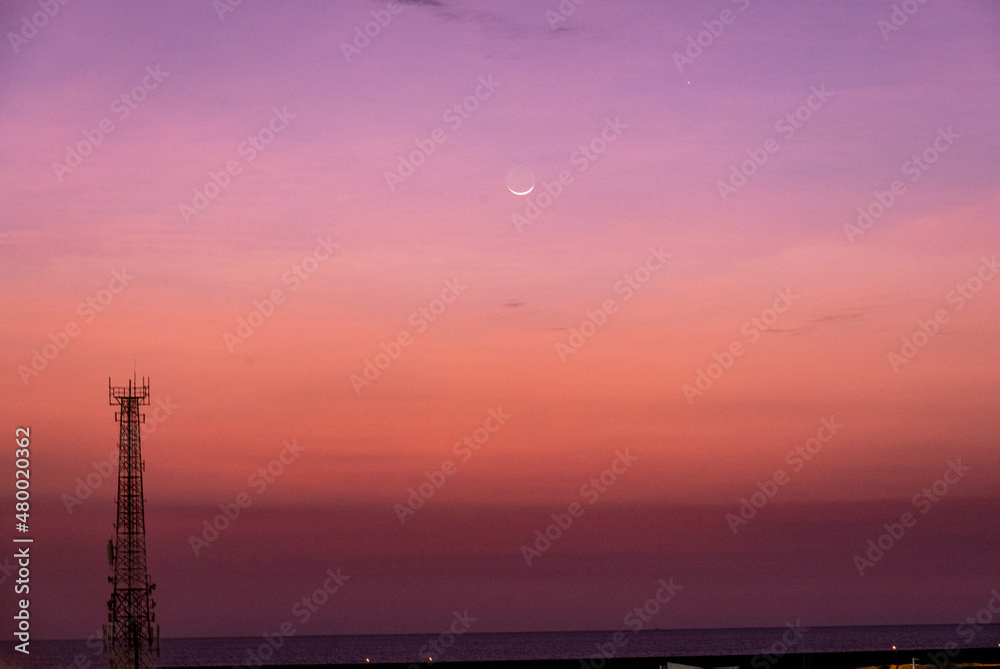 red sunset with young moon in the landscape 