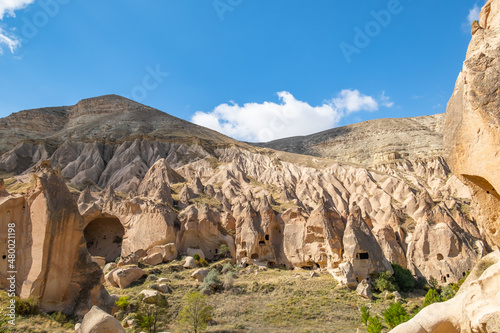 Fairy chimneys in Cappadocia Valley, Zelve Open Air Museum Turkey. Mushroom-shaped volcanic rocks known as fairy chimneys in Cappadocia. Ancient churches and houses carved into the rocks.