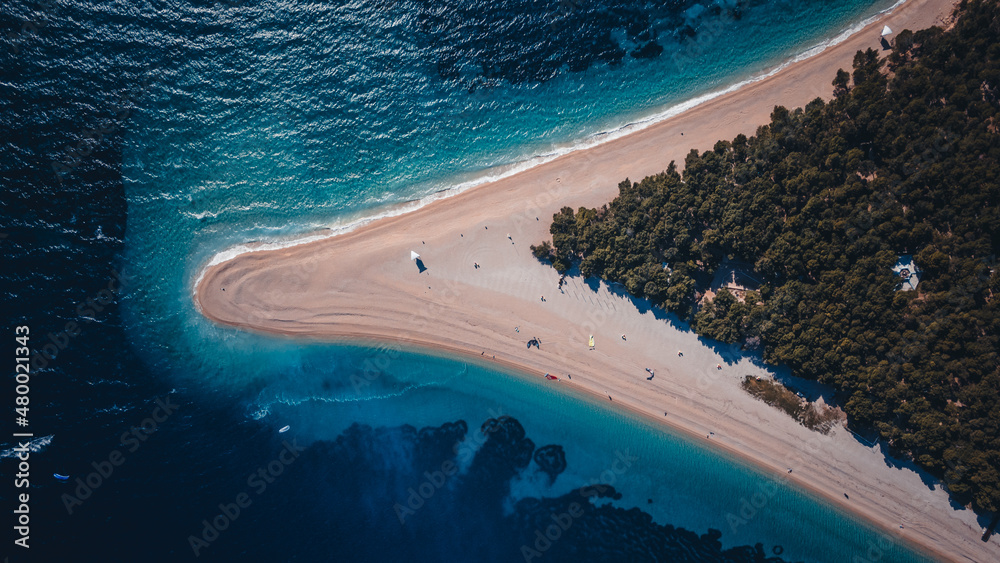 Croatia, Hvar island, Bol. Aerial view at the Zlatni Rat. Aerial view of luxury floating boat on blue Adriatic sea at sunny day