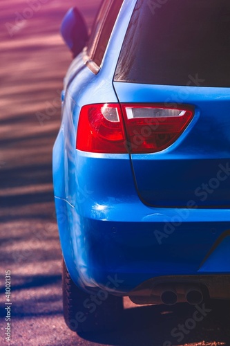 Close up view of rear headlight of blue car. Back side, half.