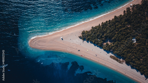 Croatia, Hvar island, Bol. Aerial view at the Zlatni Rat. Aerial view of luxury floating boat on blue Adriatic sea at sunny day