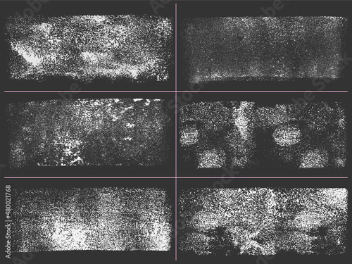 Set of subtle gritty texture. Paint grit design element. Speckle vector graphic on dark background. Distressed grunge style effect.