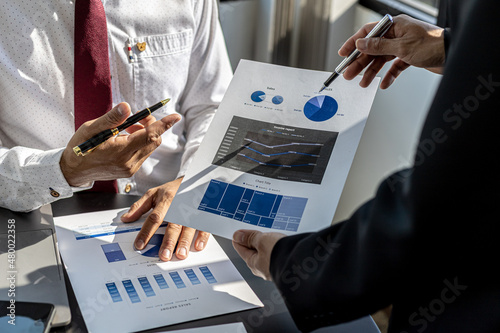 The sales department is having a monthly summary meeting to bring it to the department manager, they are verifying the correctness of the documents that are prepared before bringing in to the manager