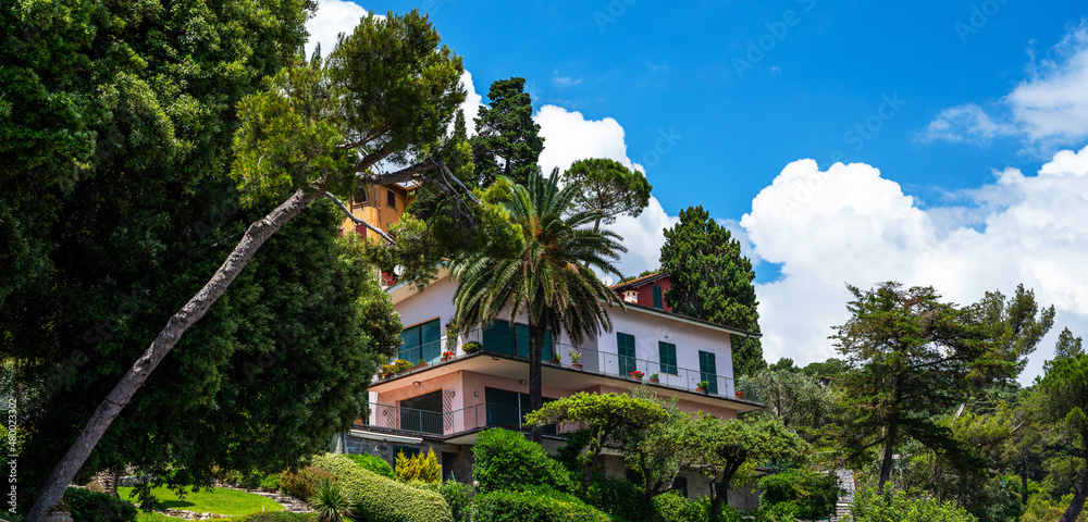 Morning view of Liguria coastline of mediterranean sea. Luxury villa in stunning botanical garden with mediterranean plants. Italy, Europe. Cloudy blue sky sunny day idyllic scenery.