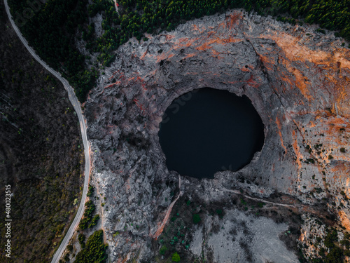 Aerial drone picture of massive crater, blue hole (red lake) in April at Imotski, Dalmatia, Croatia