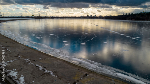 Aerial view of a frozen lake at sunset