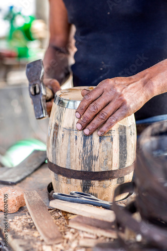 craftsman builds wooden barrels,