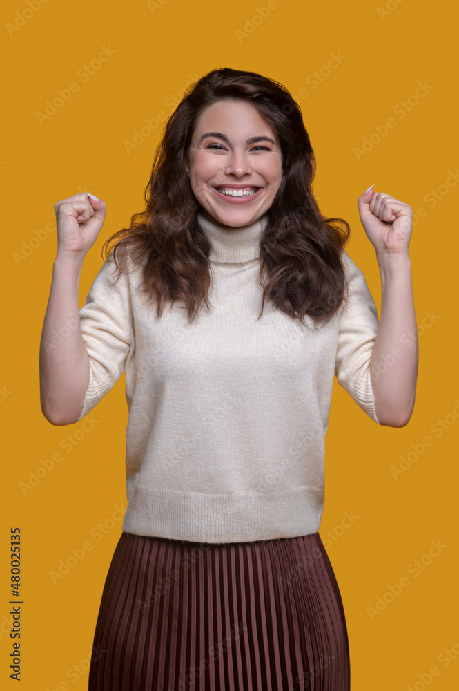 Joyful trendy lady demonstrating her energy before the camera Joyful trendy lady demonstrating her energy before the camera