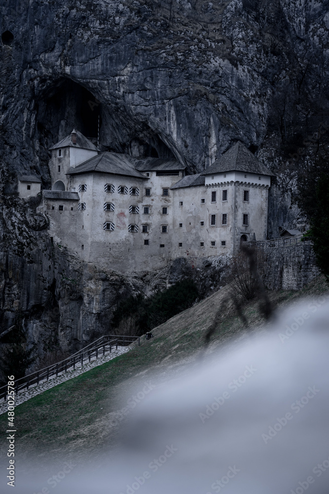 Moody, dark Predjama castle - Predjamski grad in spring, Slovenia