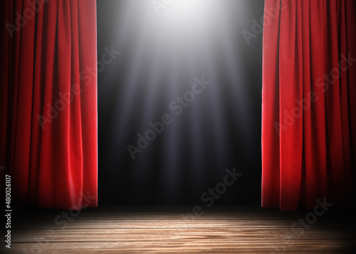 Empty wooden stage and open red curtains