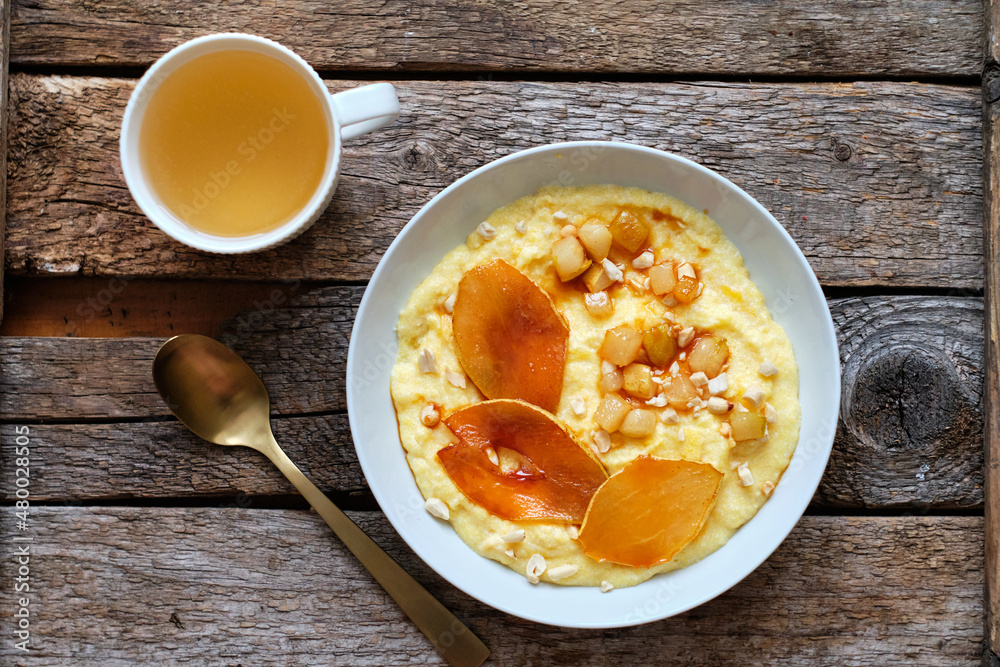 plate of sweet polenta with milk and caramelized pears, nuts. plate of sweet polenta with milk and caramelized pears, nuts.