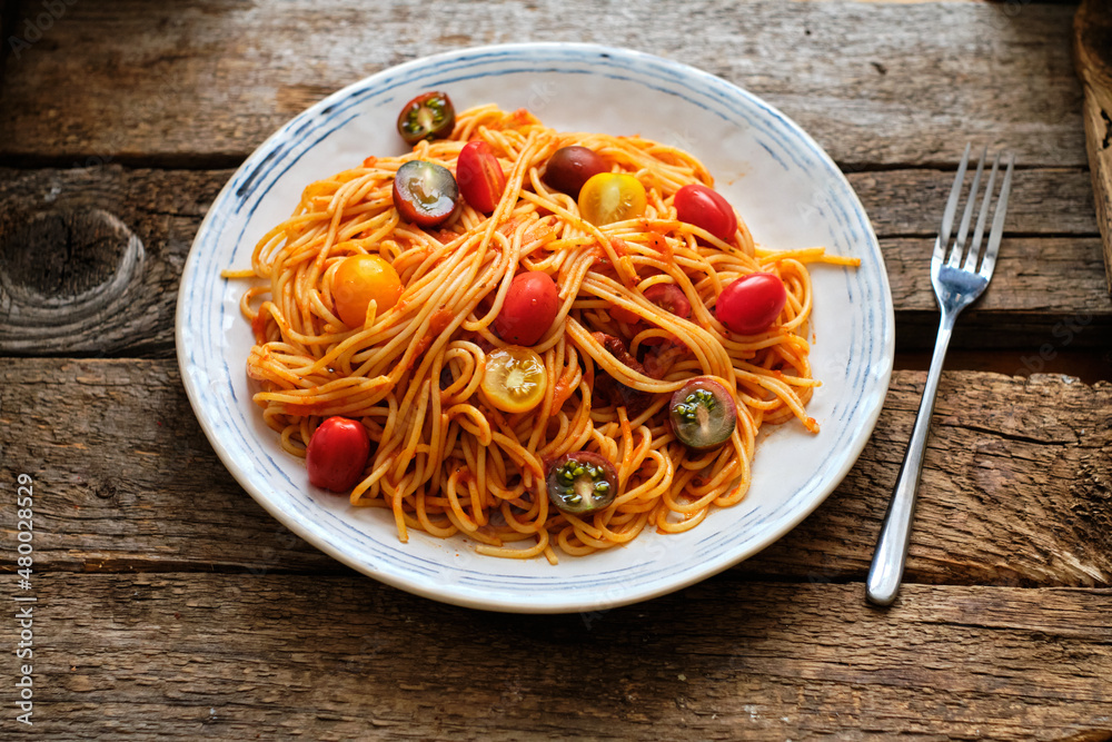 spaghetti with tomato sauce. Side view, wooden background, horizontal spaghetti with tomato sauce. Side view, wooden background, horizontal
