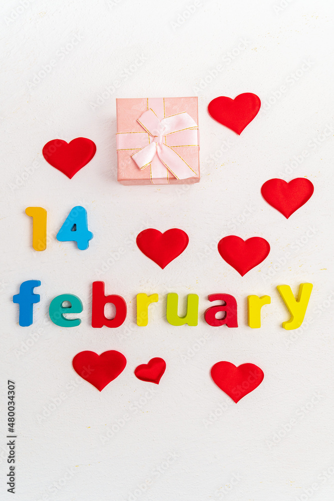 Valentines Day a white background. A gift box with the inscription February 14. Top view. Vertical photo
