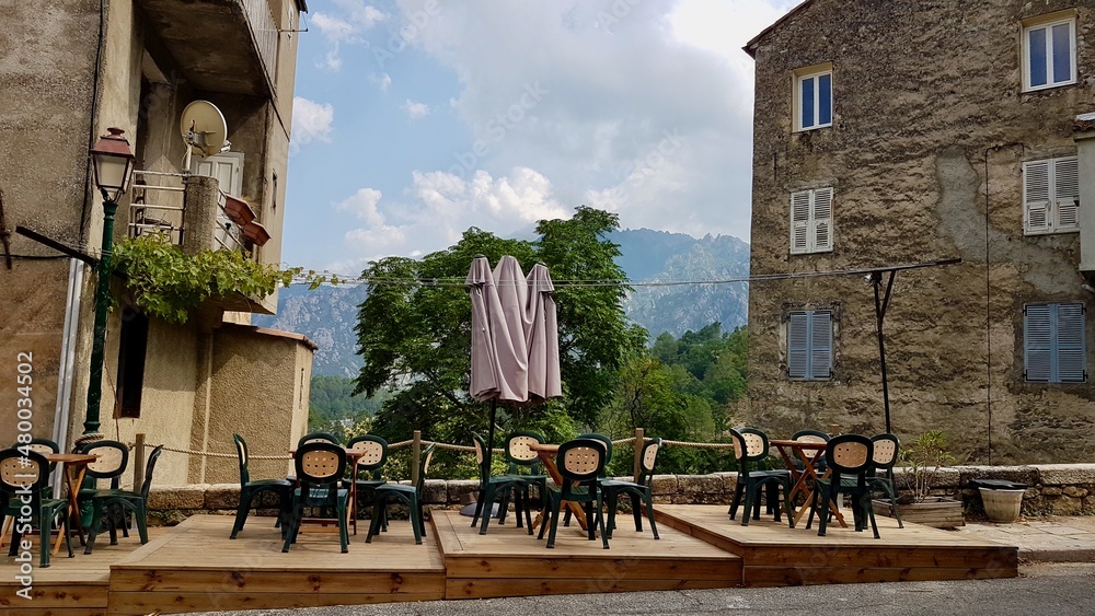 Outdoor seating of cafe in Ghisoni, a dreamy mountain village popular with hikers. Corsica, France.