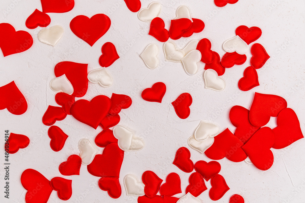 Background with heart shaped decorations on a white textured surface. The mood of tenderness and love. Valentines Day Symbols