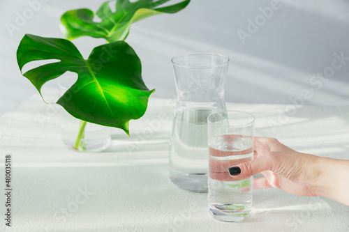 Females hand holds a glass of clean water