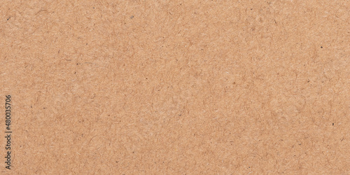 Light brown texture. Cardboard packaging. Beige parchment, manuscript. Rough background. Natural surface of a sheet of old paper.