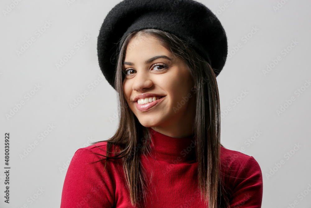 Portrait of attractive young woman in red dress and black beret. Portrait of attractive young woman in red dress and black beret.