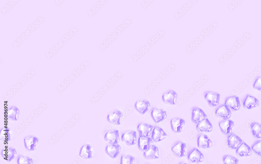 St Valentines day violet background border. Many glass hearts flat lay. Love or wedding concept St Valentines day violet background border. Many glass hearts flat lay. Love or wedding concept
