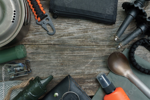 Hiking gear on wooden background 