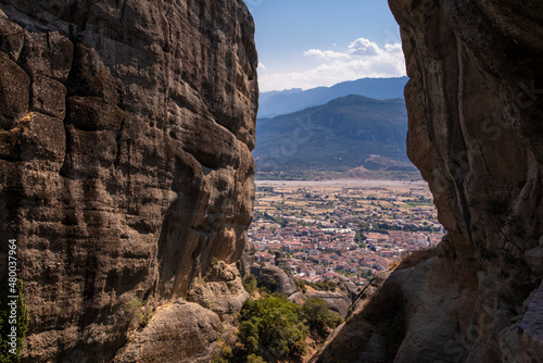 Beautiful scenic view of the small Kalabaka town on top of the cliff, from Holy Trinity Monastery (Agia Trias), trough Meteora rock formations, Greece.