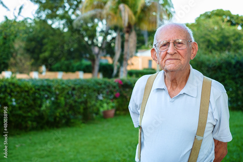 Elderly eighty year old man outdoors in a home setting