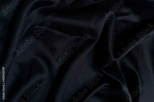 Fotografie Black crumpled or wavy fabric texture background