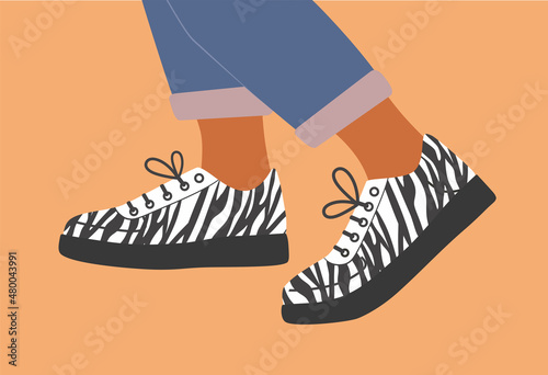 Shoe pair, boots, footwear. Sneakers  shoes. Legs in sneakers with with zebra print and jeans. Fashion glamour style low-top sneakers. Lace-up shoes. Walking. Color Isolated flat vector illustration.