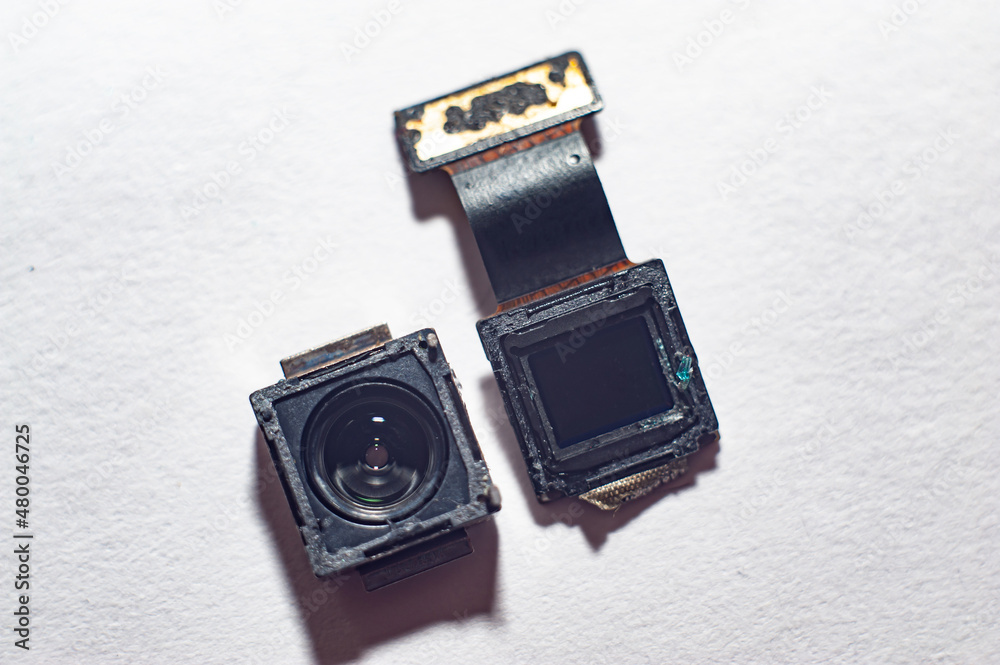 Fotografie The camera from the smartphone lies wight background