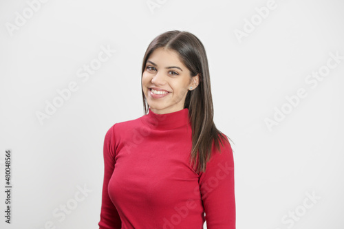 Studio portrait of attractive young woman in red 