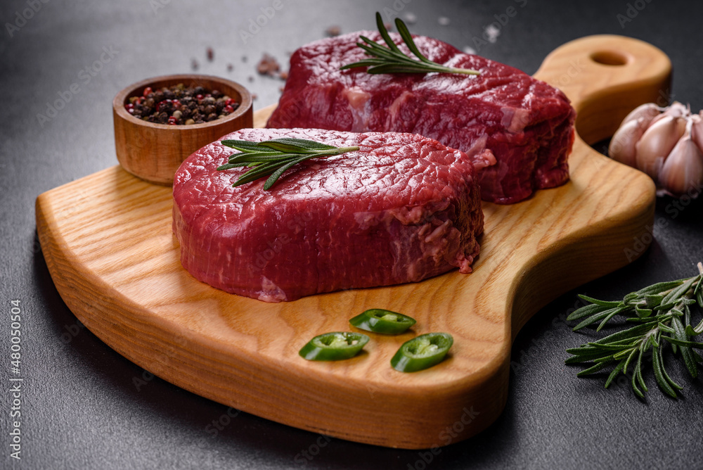 Raw fillet steak cooking on stone table. Raw meat Raw fillet steak cooking on stone table. Raw meat
