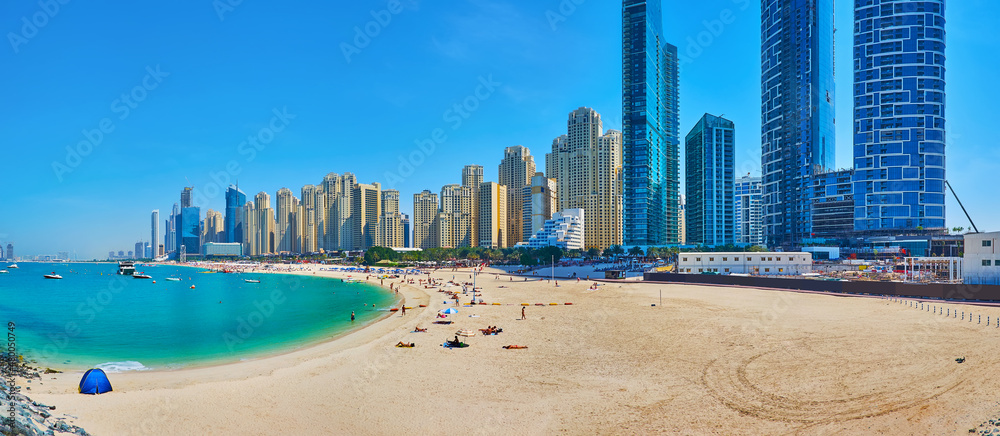 Panorama of JBR Marina sand beach, lined with futuristic skyscrapers, Dubai, UAE
