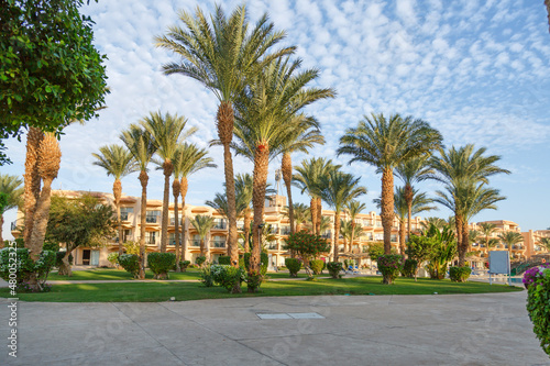 Hurghada, Egypt. Egyptian garden with palm trees in hotel .Swimming pool and accommodation at tropical resort. Buildings, swimming pools and a recreation area by the red sea. All iclusive holidays.