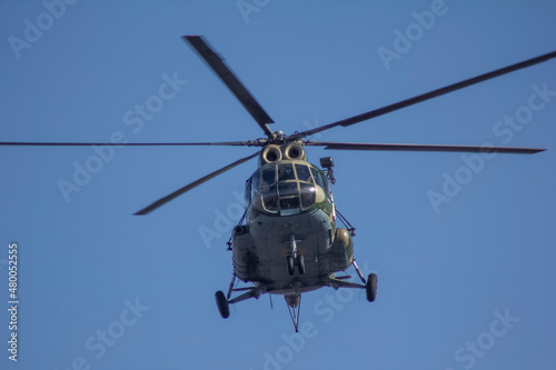 Fototapeta Naklejka Na Ścianę i Meble -  Military tranA military transport helicopter comes in for a landing, against the backdrop of a clear skysport helicopter comes in for landing, 