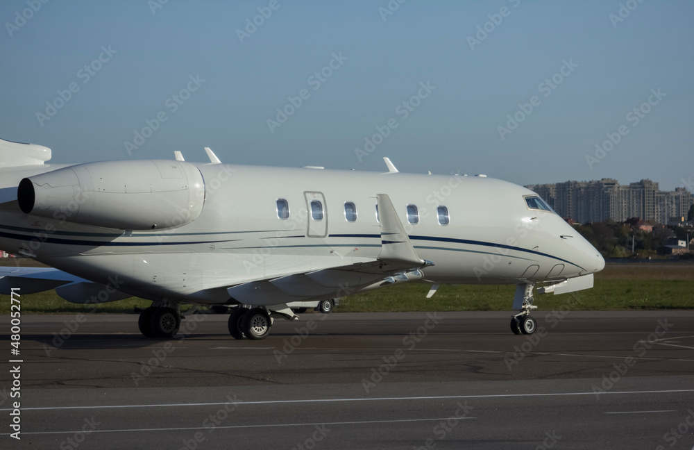 Private jet airliner parked at the airport in sunny weather Private jet airliner parked at the airport in sunny weather